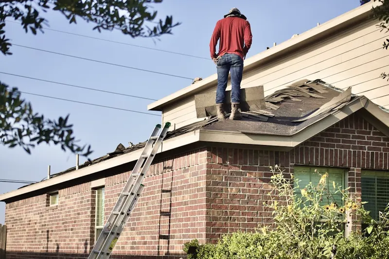 Professional roofer working on a residential roof in South Jamesport